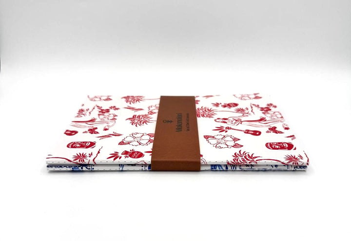 Side view of two notebook set showing the woven spine and craft paper packaging