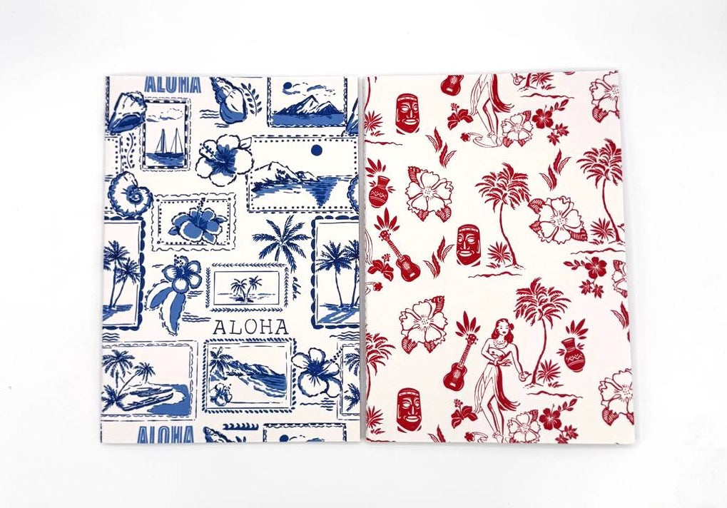 Two notebooks with tropical patterns on a white background