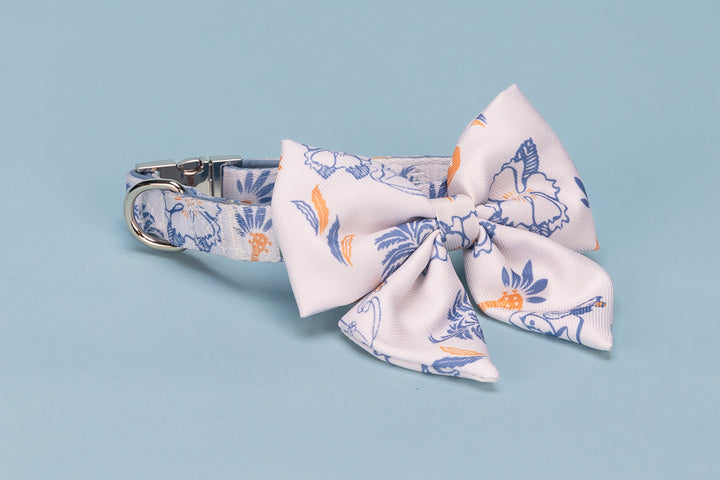 Floral dog collar with a bow tie on a light blue background