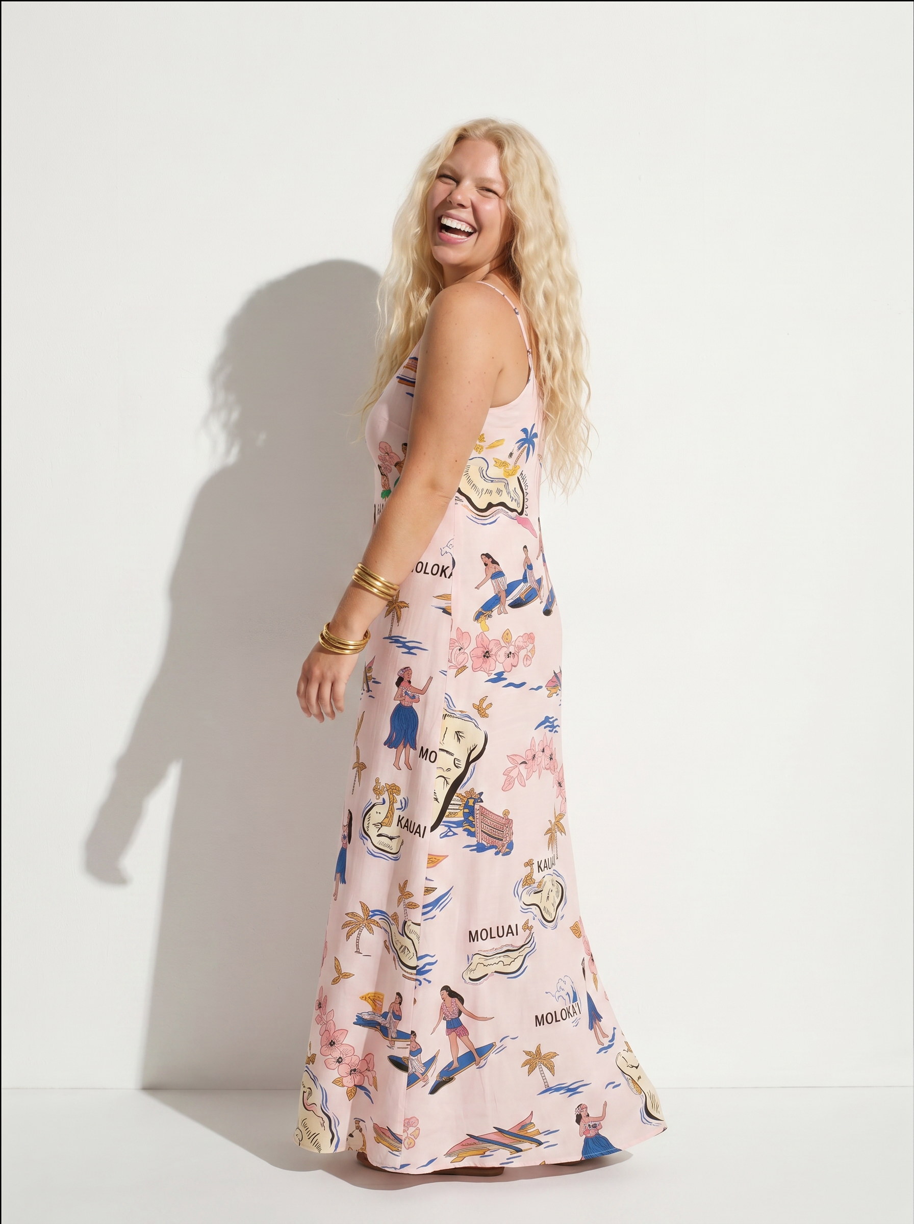 Women wearing light pink maxi dress on white background