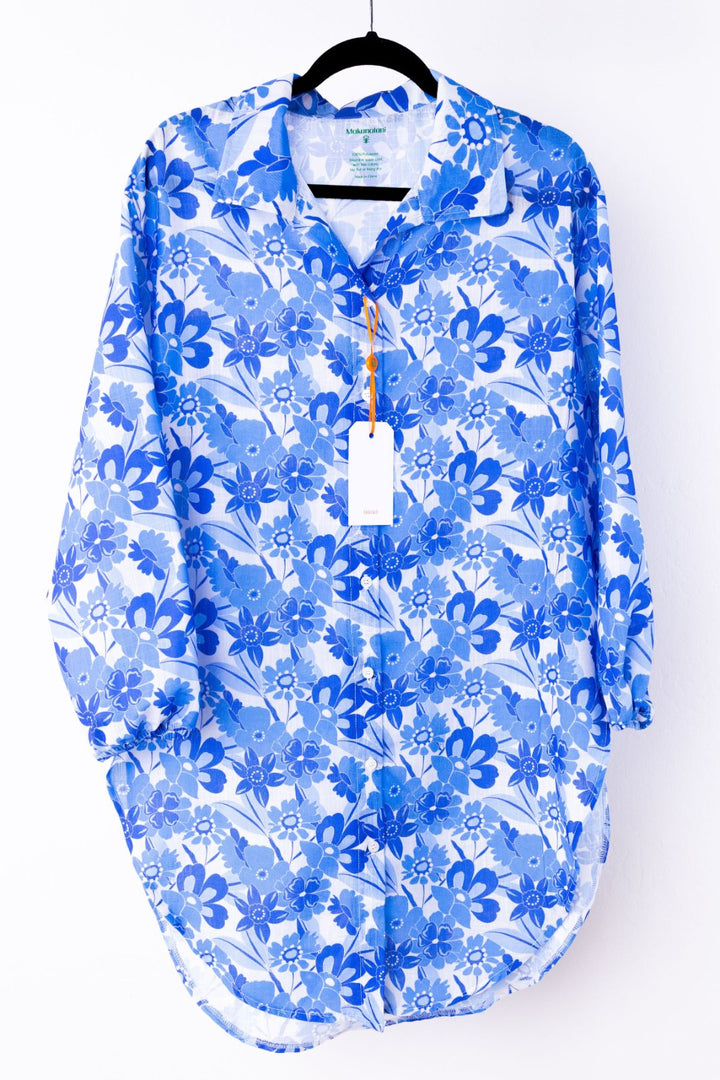 Blue floral patterned swim cover-up on a hanger with a white background