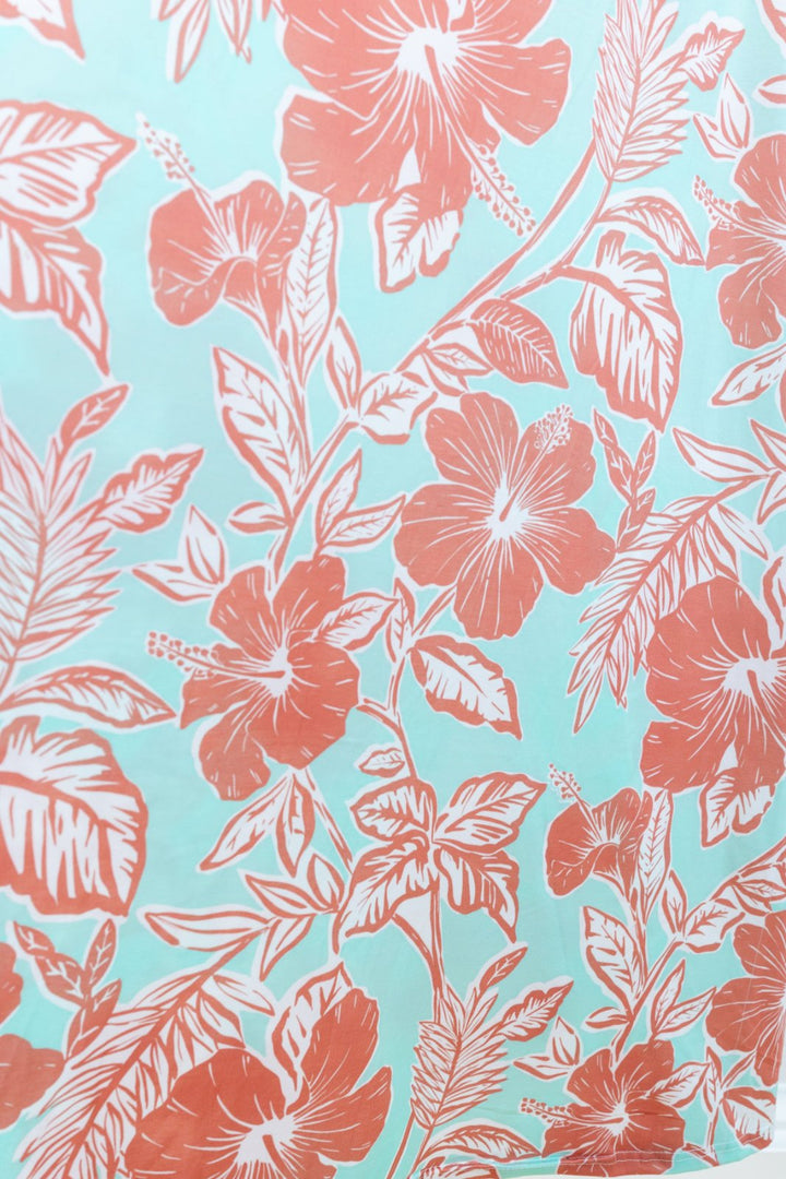 Floral pattern with pink flowers and leaves on a turquoise background