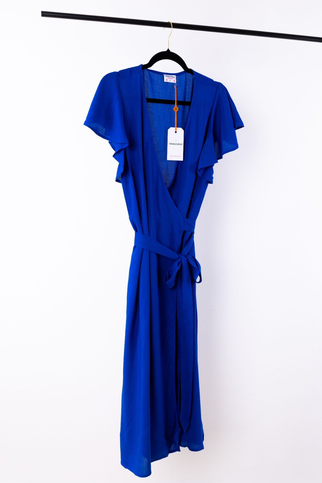 Blue dress on a hanger with a white background