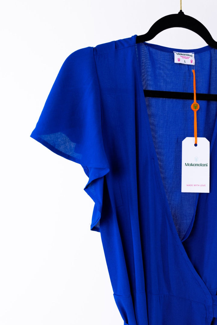 Blue garment on a hanger with a visible brand tag against a white background