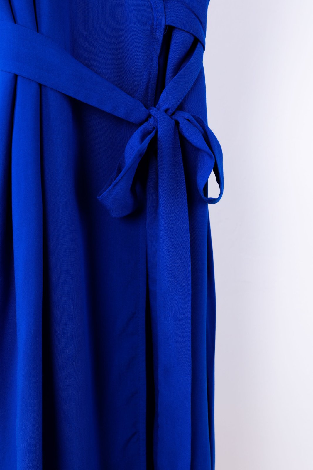 Blue dress with a tie detail on a white background